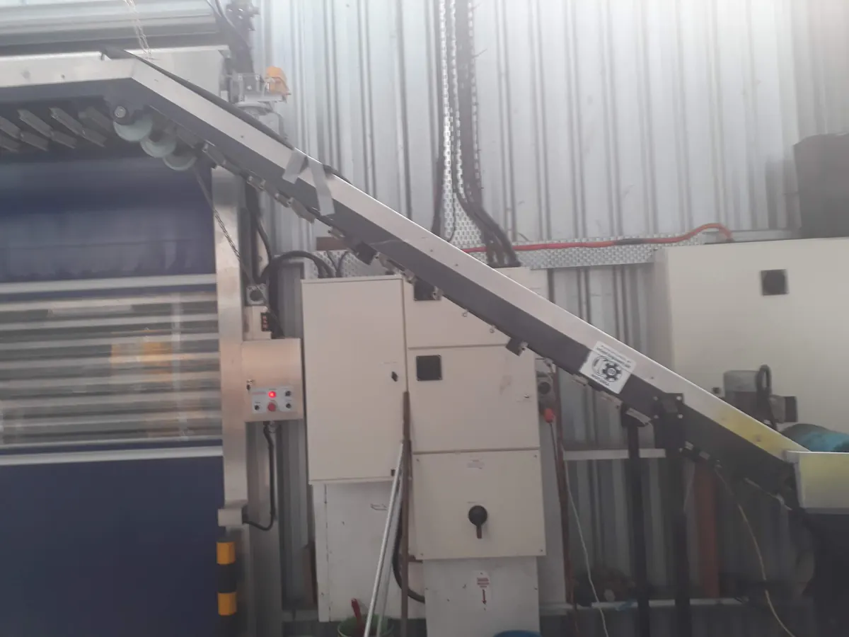 Incline conveyor line inside an industrial facility