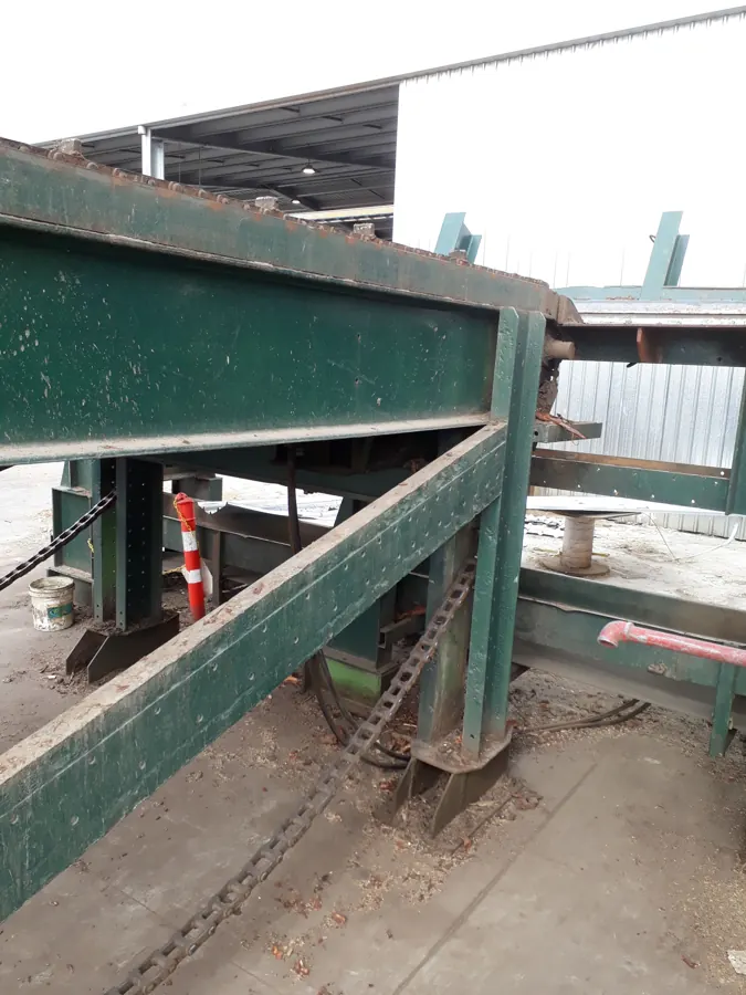 Green conveyor frame and underside components being inspected